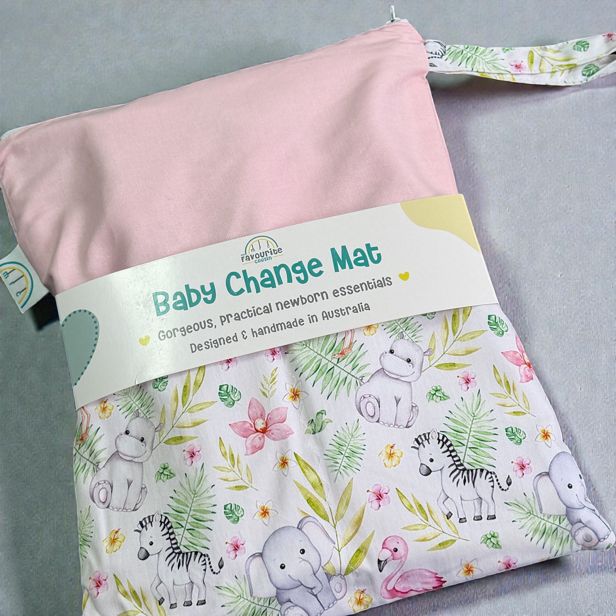 Baby change mat with jungle animal pattern and pink cover on a gray background