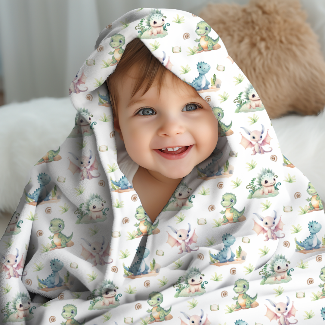 cute baby wrapped in a dinosaur dragon printed swaddle