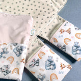 baby change mat with 2 pockets hippos elephants in pink