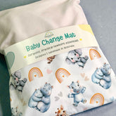 Baby change mat with cartoon animals and rainbow design on a gray surface