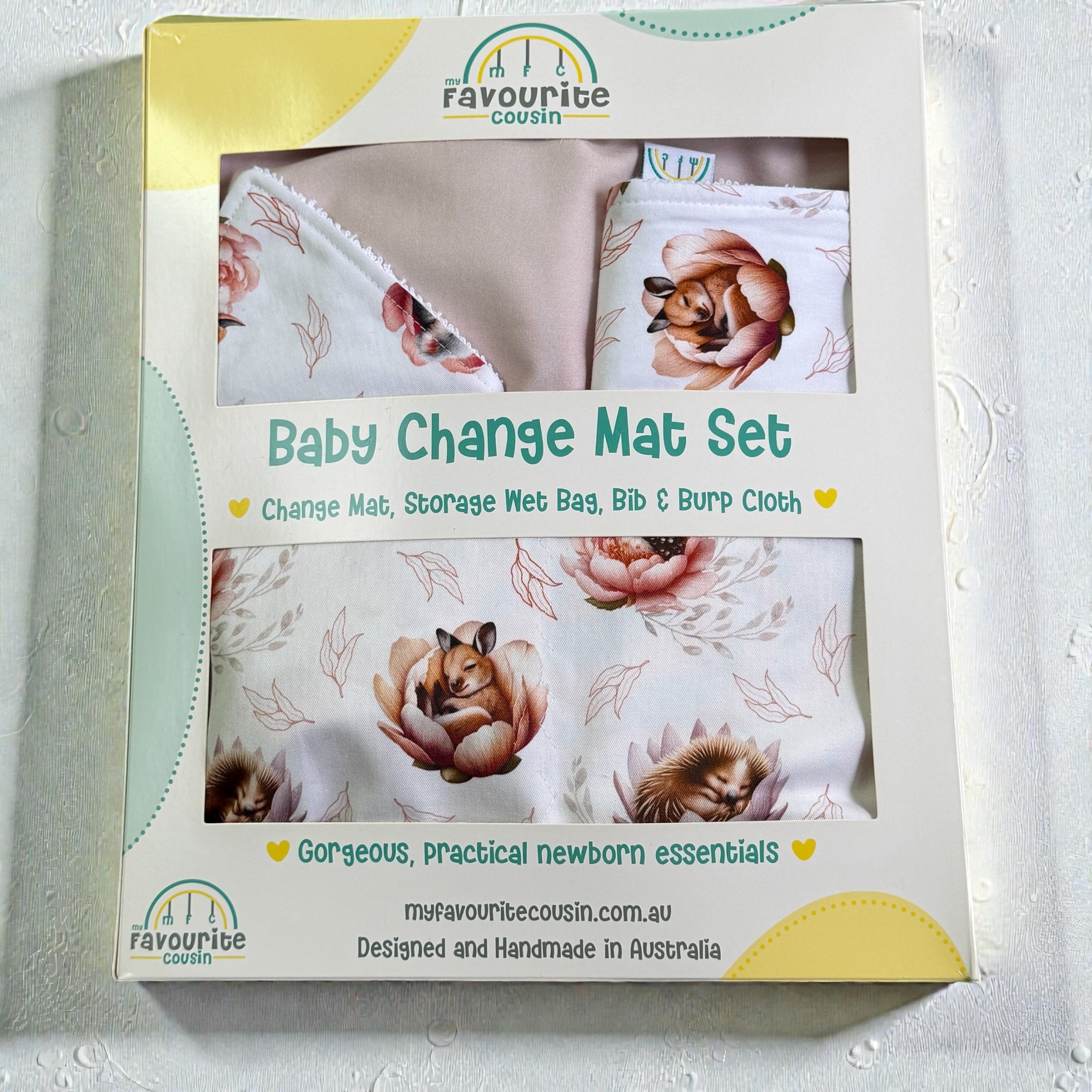 Baby change mat set packaging with floral design and text on a light background